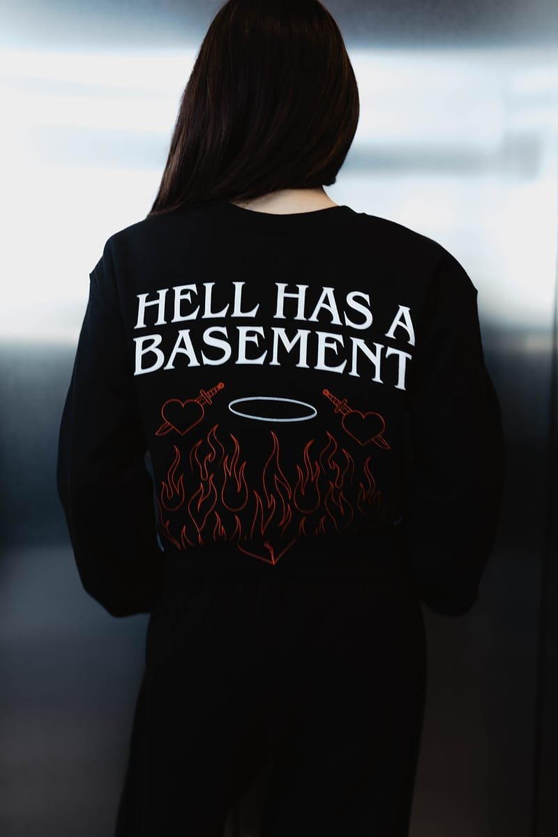 The HELL HAS A BASEMENT crewneck photographed from behind